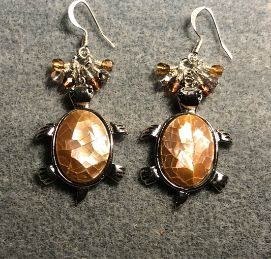 Large silver and beige shell turtle charm earrings adorned with small dangling amber, beige, and silver Czech glass beads.