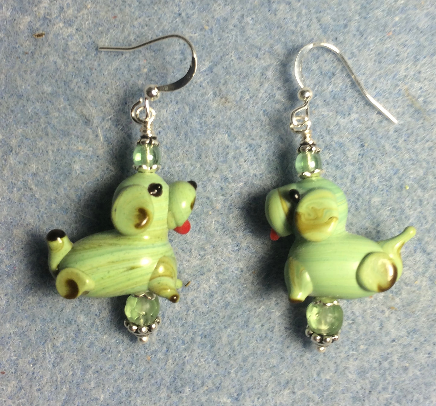 Green lamp work puppy dog bead earrings adorned with green Czech glass beads.