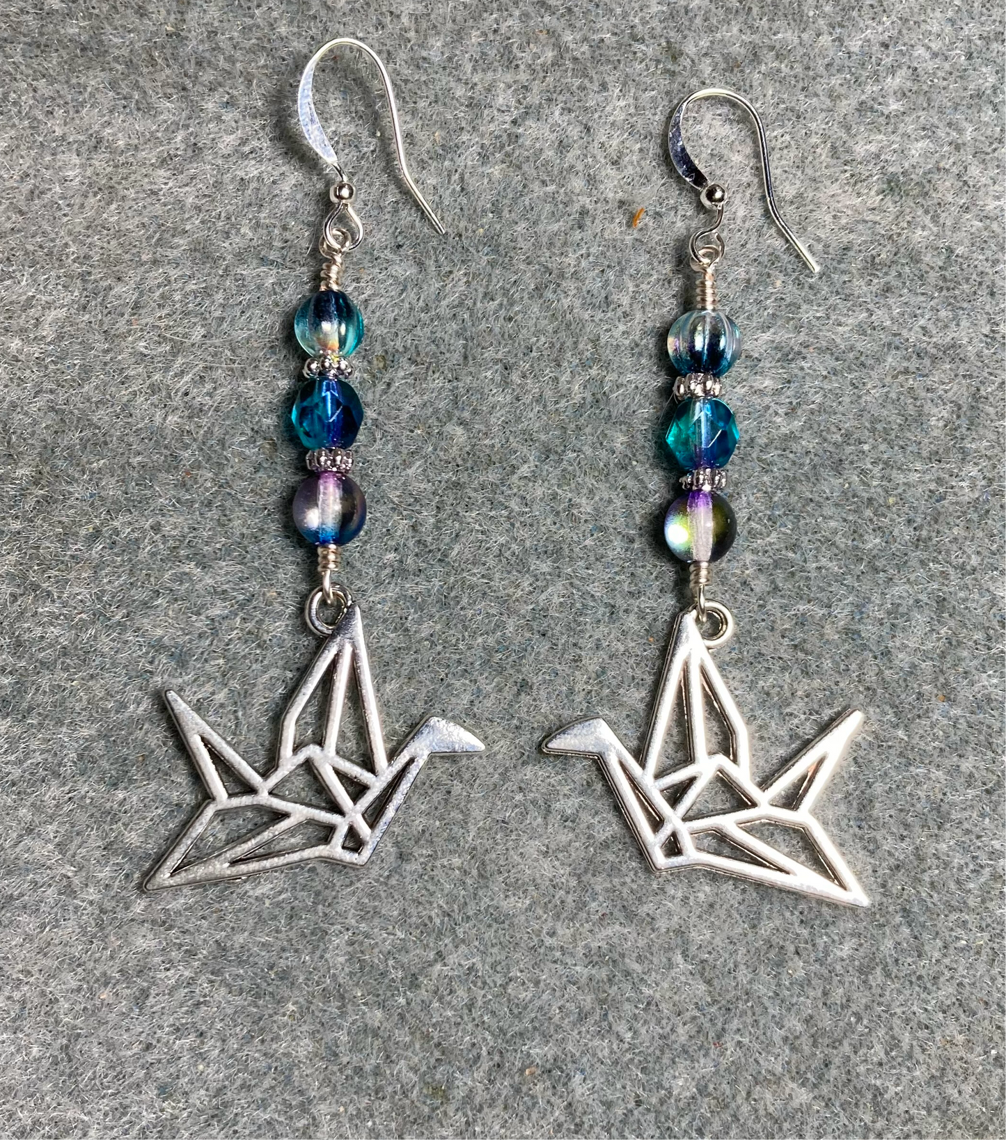 Silver origami crane charm earrings adorned with blue purple Czech glass beads