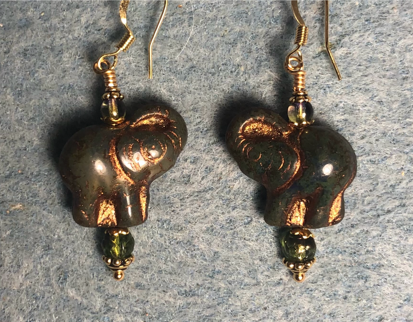 Opaque dark green (with gold inlay) Czech glass elephant bead earrings adorned with dark green Czech glass beads.