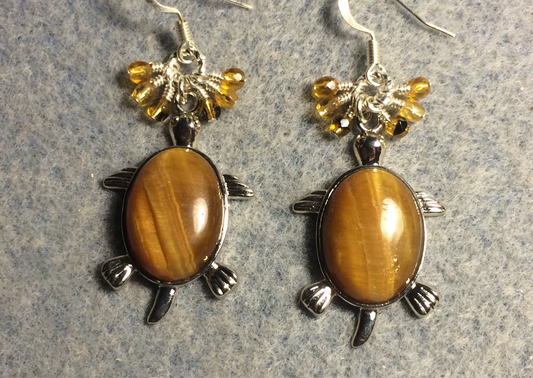 Large silver and amber tigereye gemstone turtle charm earrings adorned with small dangling amber and topaz Czech glass beads.