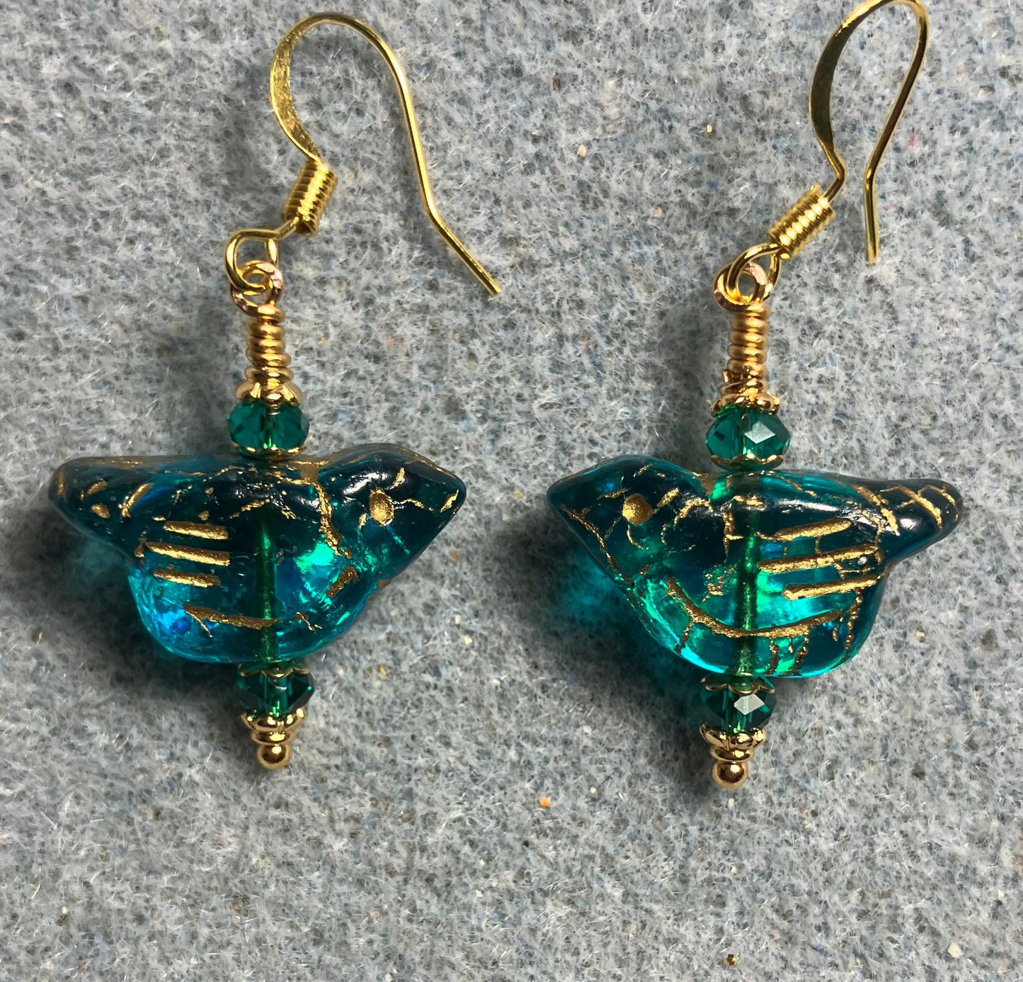 Teal (with gold wash) Czech glass bird bead earrings adorned with teal Chinese crystal beads.