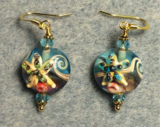 Turquoise and tan lamp work starfish bead earrings adorned with turquoise Chinese crystal beads.
