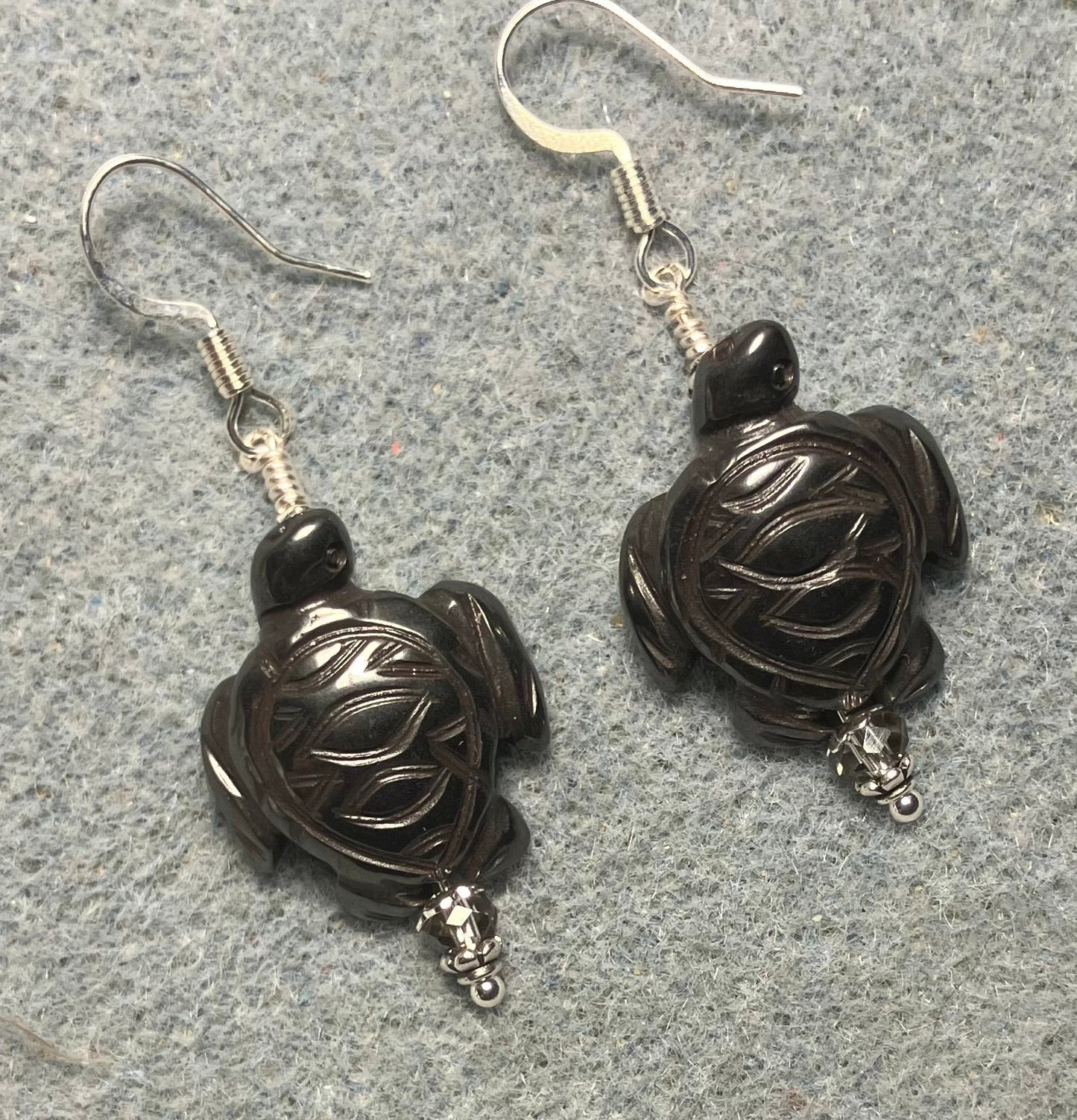 Hematite gemstone sea turtle bead earrings adorned with gray Chinese crystal beads.