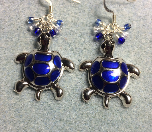 Large silver and dark blue enamel turtle charm earrings adorned with small dangling dark blue and clear Czech glass beads.