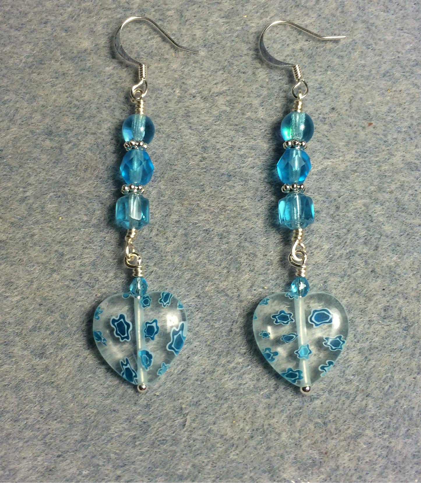 Clear and turquoise millefiori Czech glass heart bead earrings adorned with turquoise Czech glass beads.