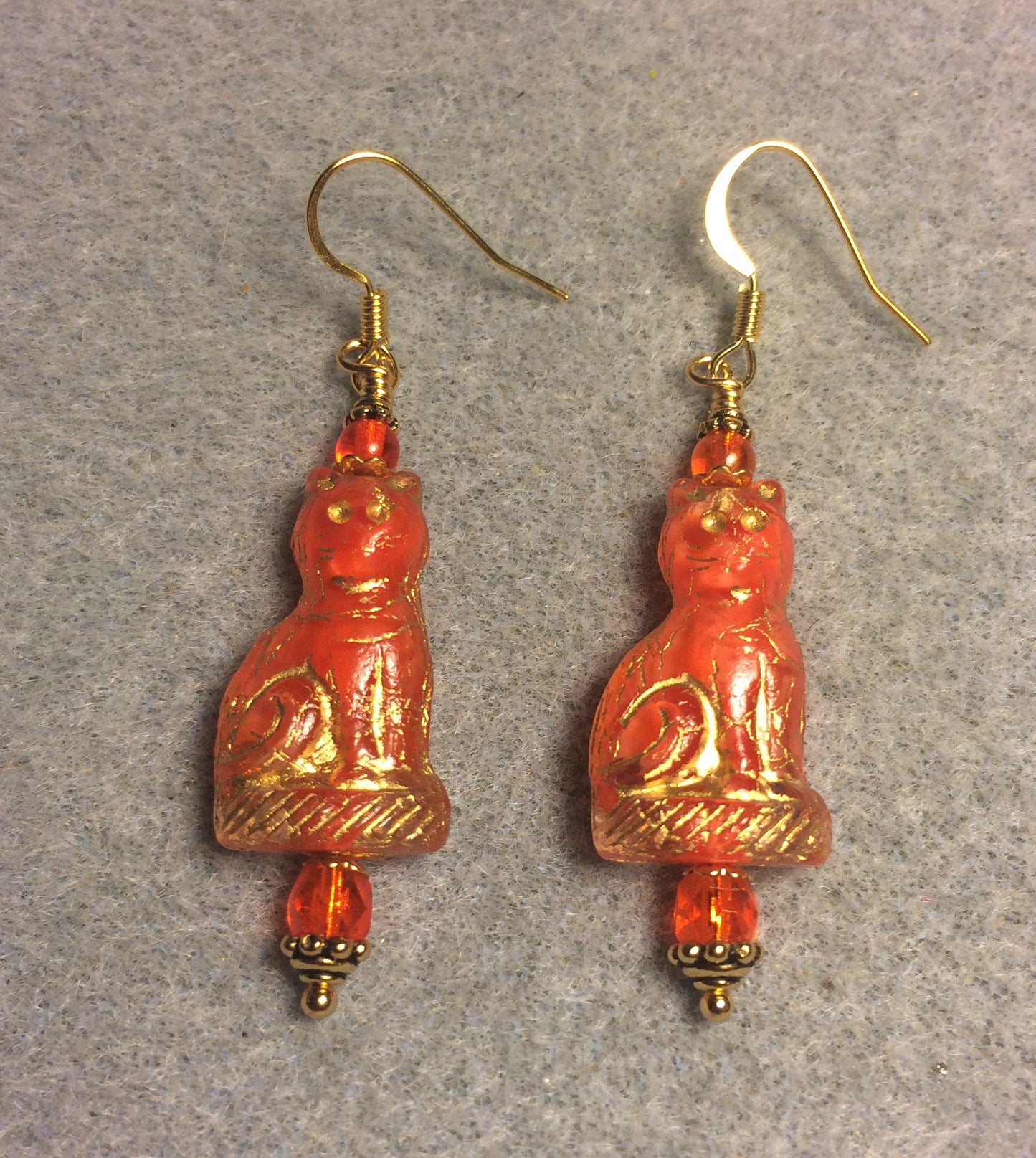 Orange (with gold inlay) fancy Czech glass cat bead earrings adorned with bright orange Czech glass beads.