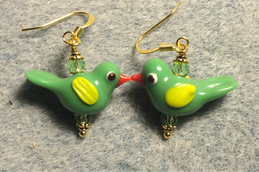 Opaque bright green and yellow lamp work songbird bead earrings adorned with green Chinese crystal beads.