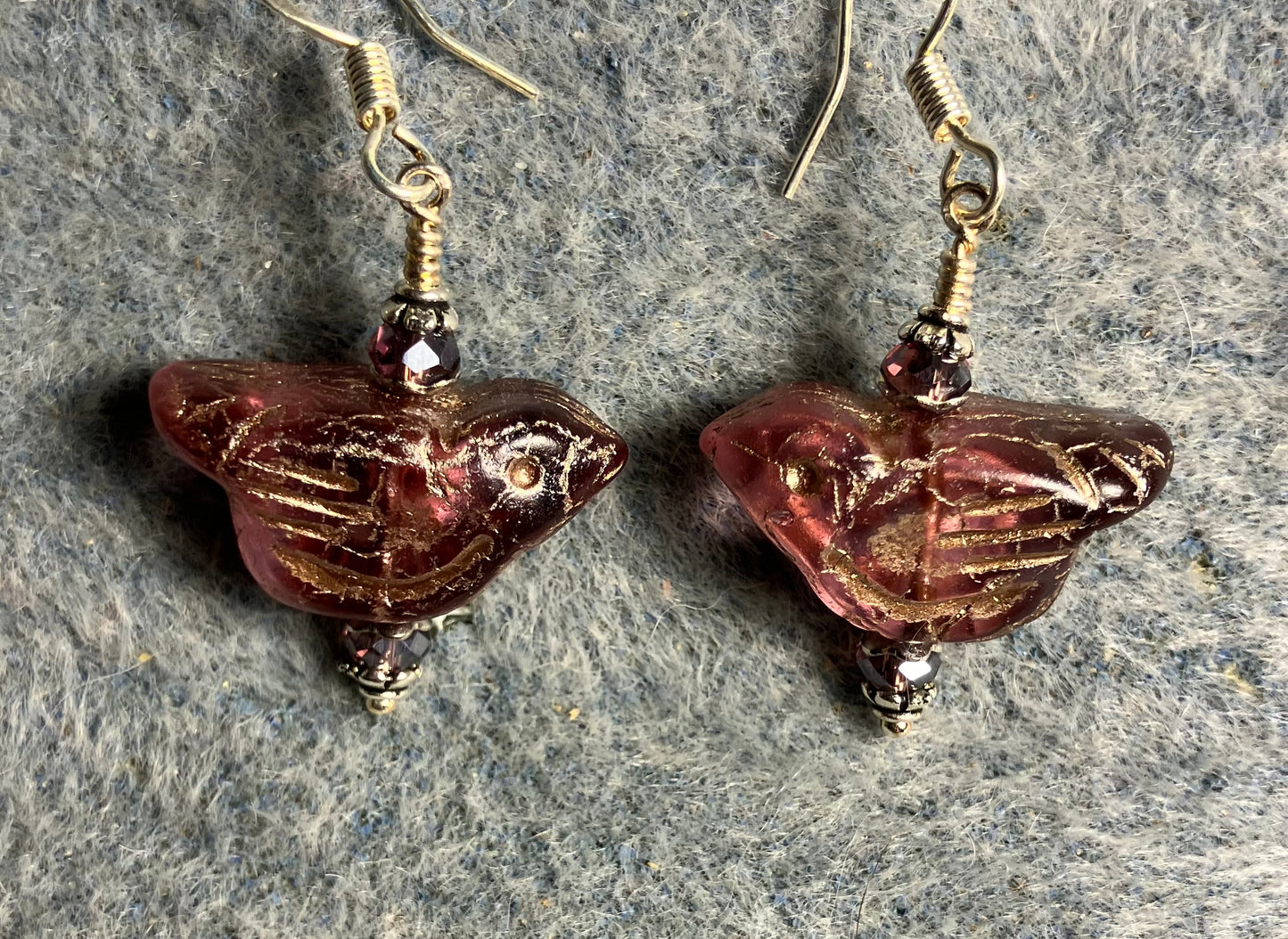 Purple (with silver wash) Czech glass bird bead earrings adorned with purple Chinese crystal beads.