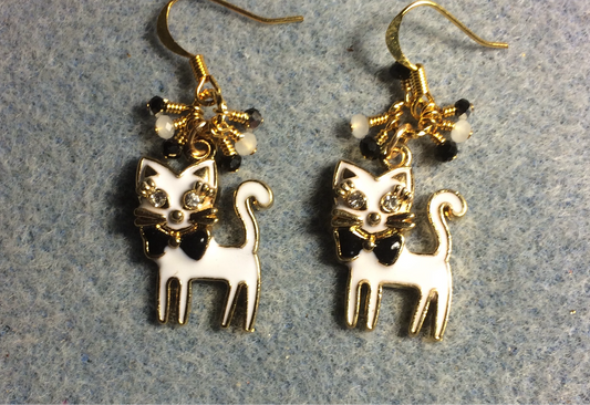 White enamel and rhinestone cat charm earrings adorned with small dangling white and black Chinese crystal beads.