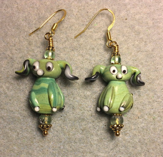 Opaque light green lamp work floppy eared puppy dog bead earrings adorned with light green Czech glass beads.