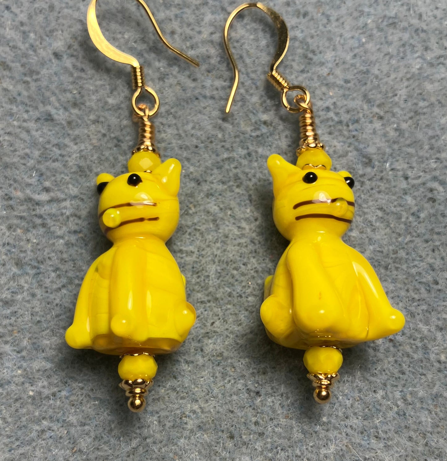 Opaque yellow lamp cat bead earrings adorned with yellow Chinese crystal beads.