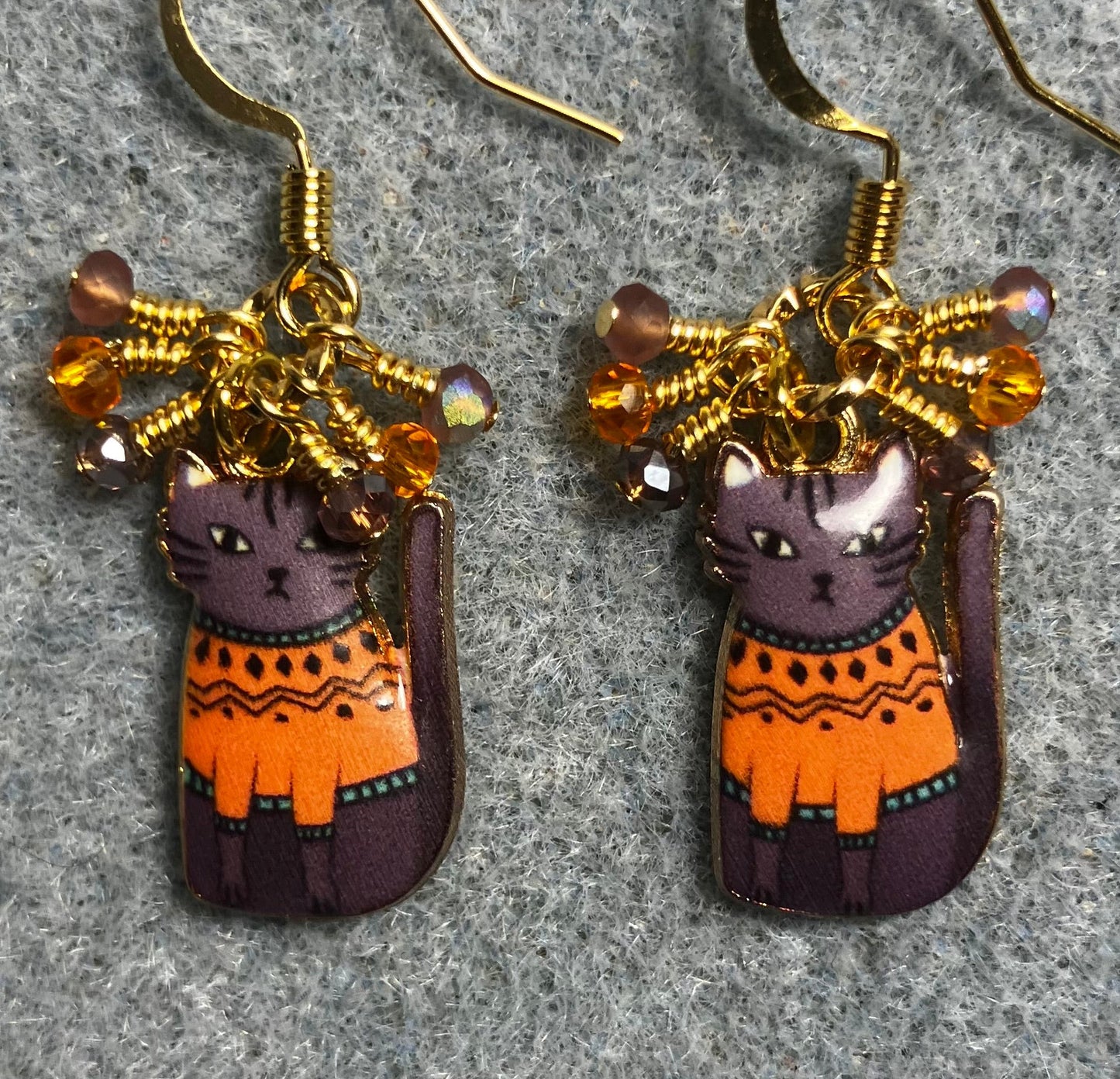 Lavender and orange enamel cat charm earrings adorned with tiny dangling lavender and orange Chinese crystal beads.