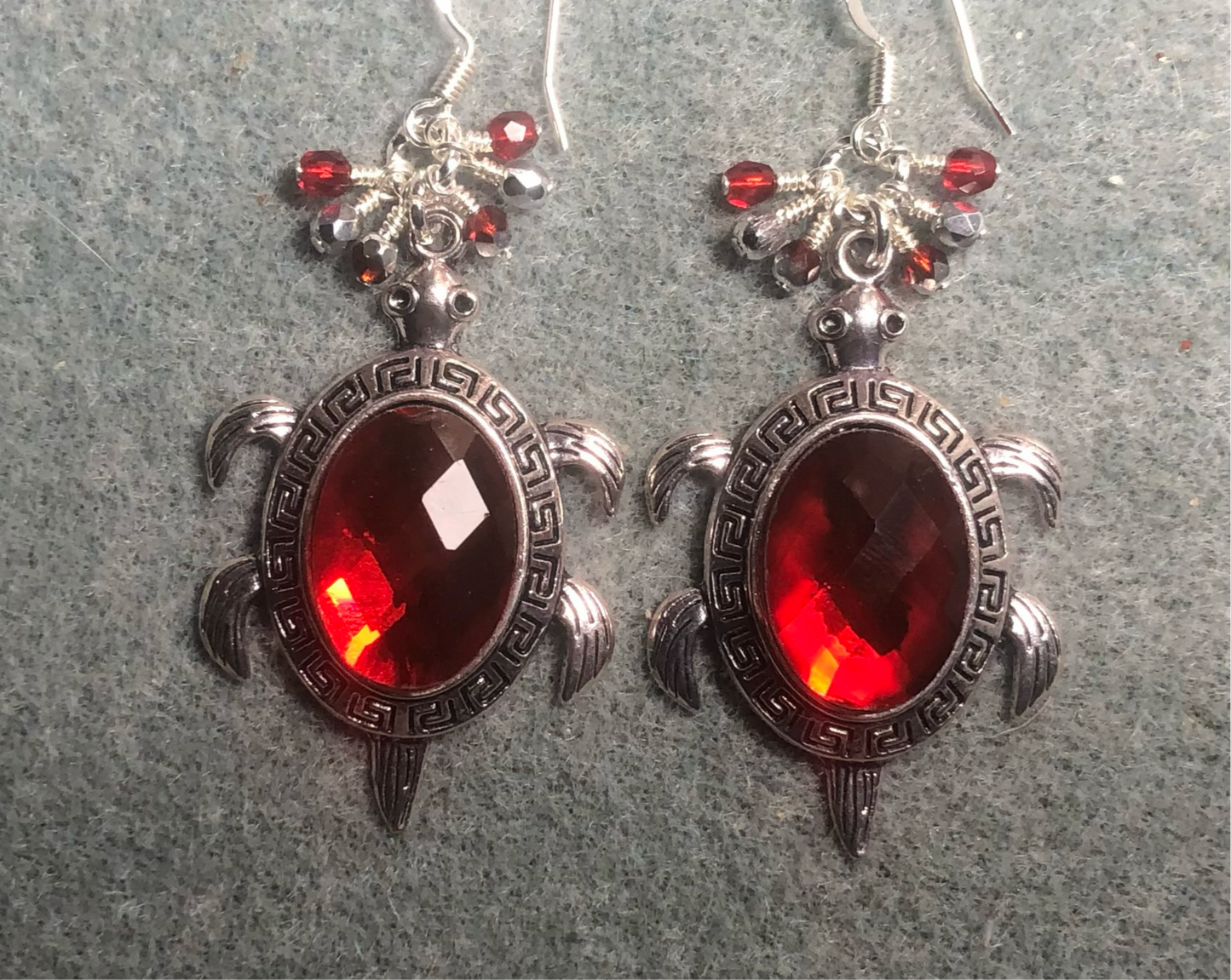 Large silver and red rhinestone turtle charm earrings adorned with small dangling red and silver Czech glass beads.