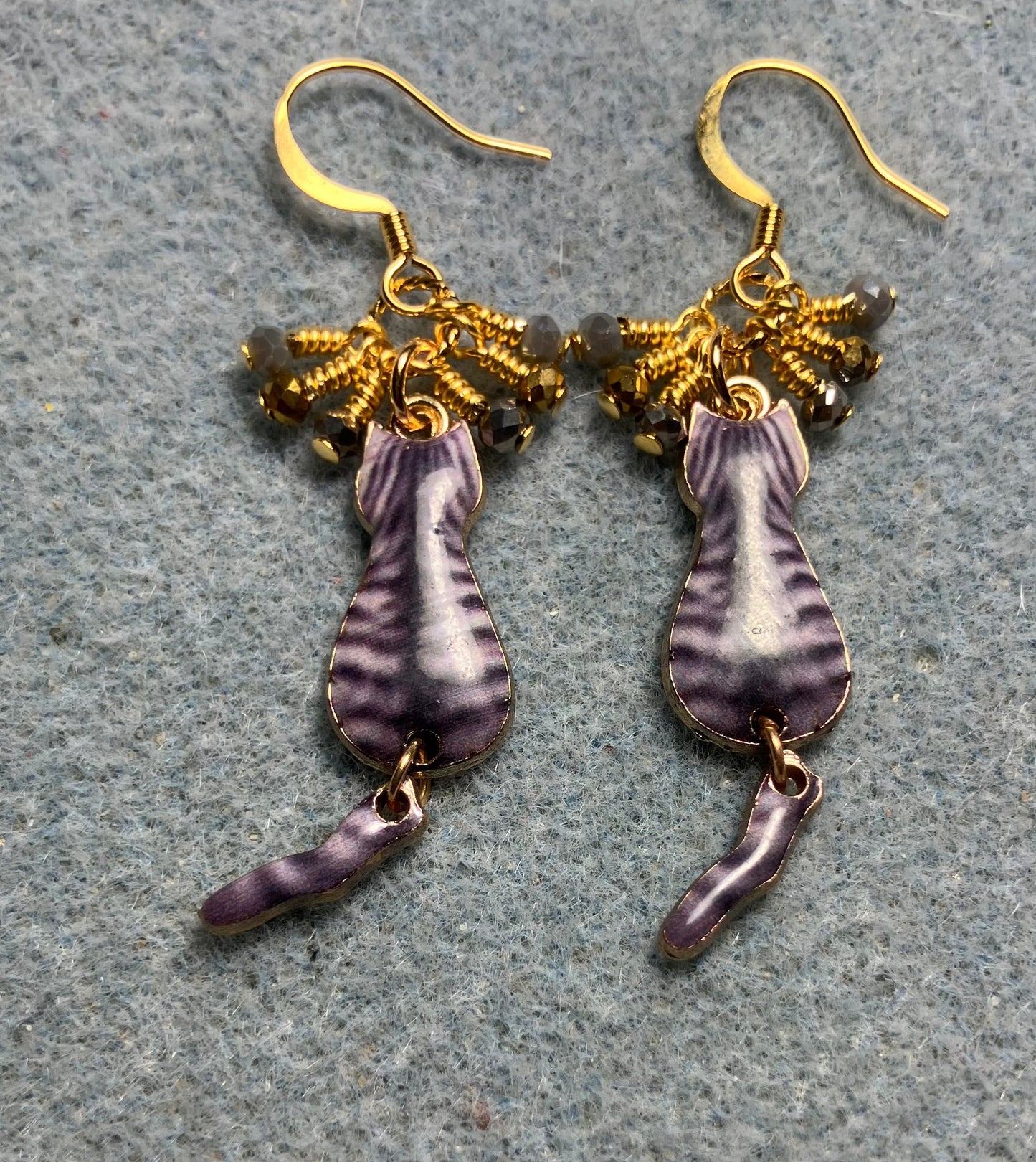 Gray and gold enamel tabby cat charm earrings adorned with tiny dangling gray and gold Chinese crystal beads.