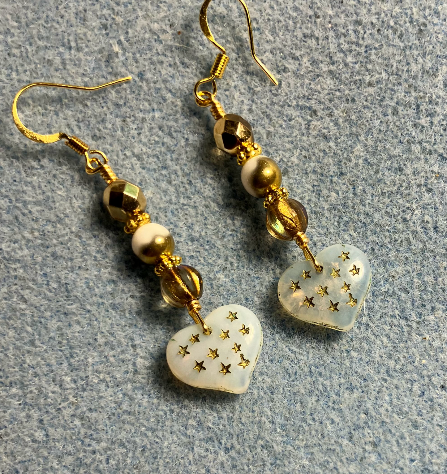 White and gold Czech glass heart bead earrings adorned with white and gold Czech glass beads.