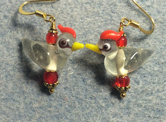 Clear and red lamp work songbird bead earrings adorned with red Czech glass beads.