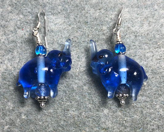 Translucent dark blue lamp work elephant bead earrings adorned with dark blue Czech glass beads.