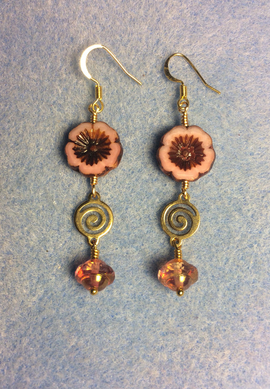 Peach Czech glass pansy bead earrings adorned with gold swirly connectors and peach Czech glass Saturn beads.