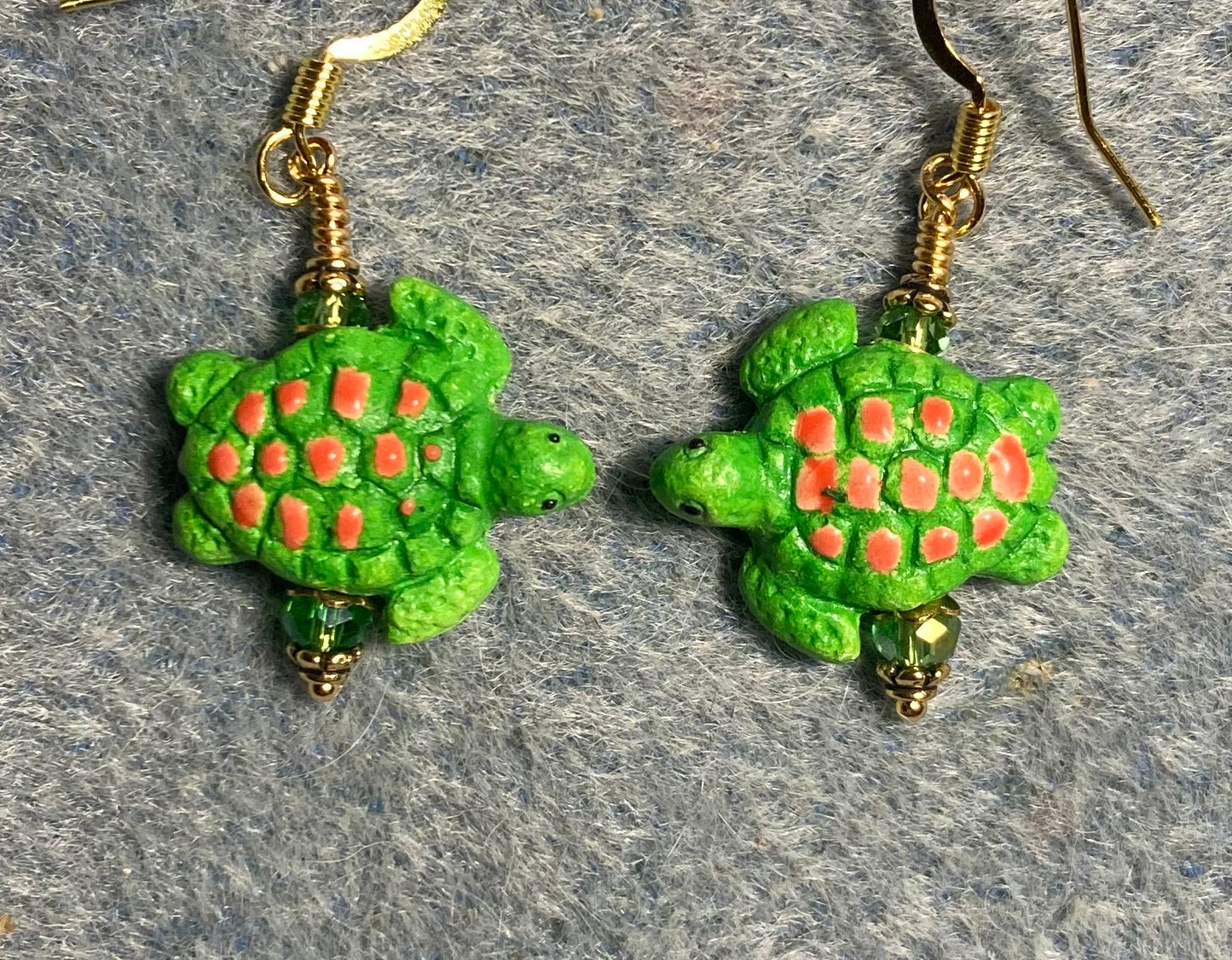 Small green and orange ceramic sea turtle bead earrings adorned with green Chinese crystal beads.