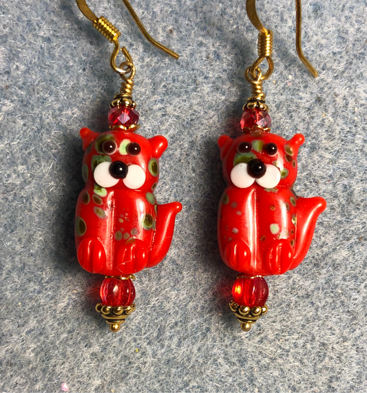 Opaque red lamp work cat bead earrings adorned with red Czech glass beads.