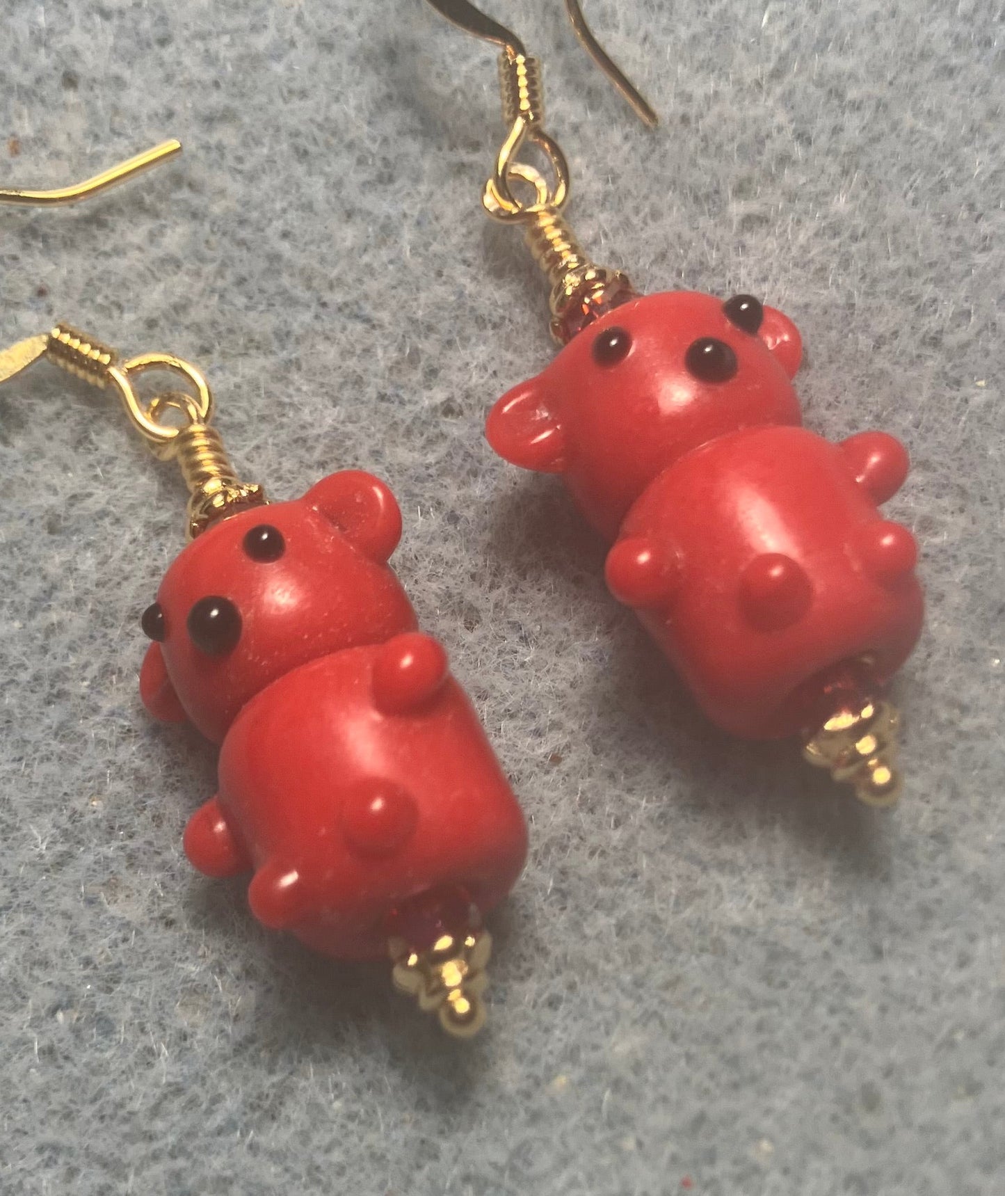 Small red lamp work teddy bear bead earrings adorned with red Chinese crystal beads.