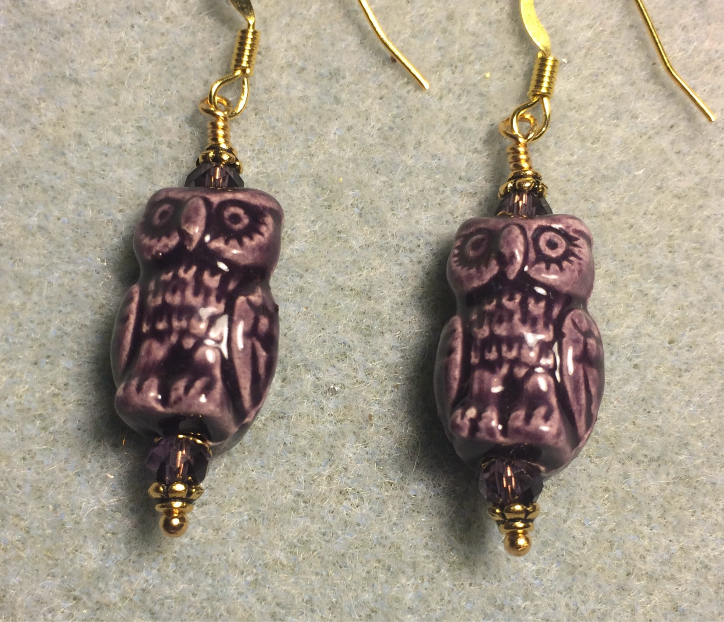 Purple ceramic owl bead earrings adorned with purple Chinese crystal beads.