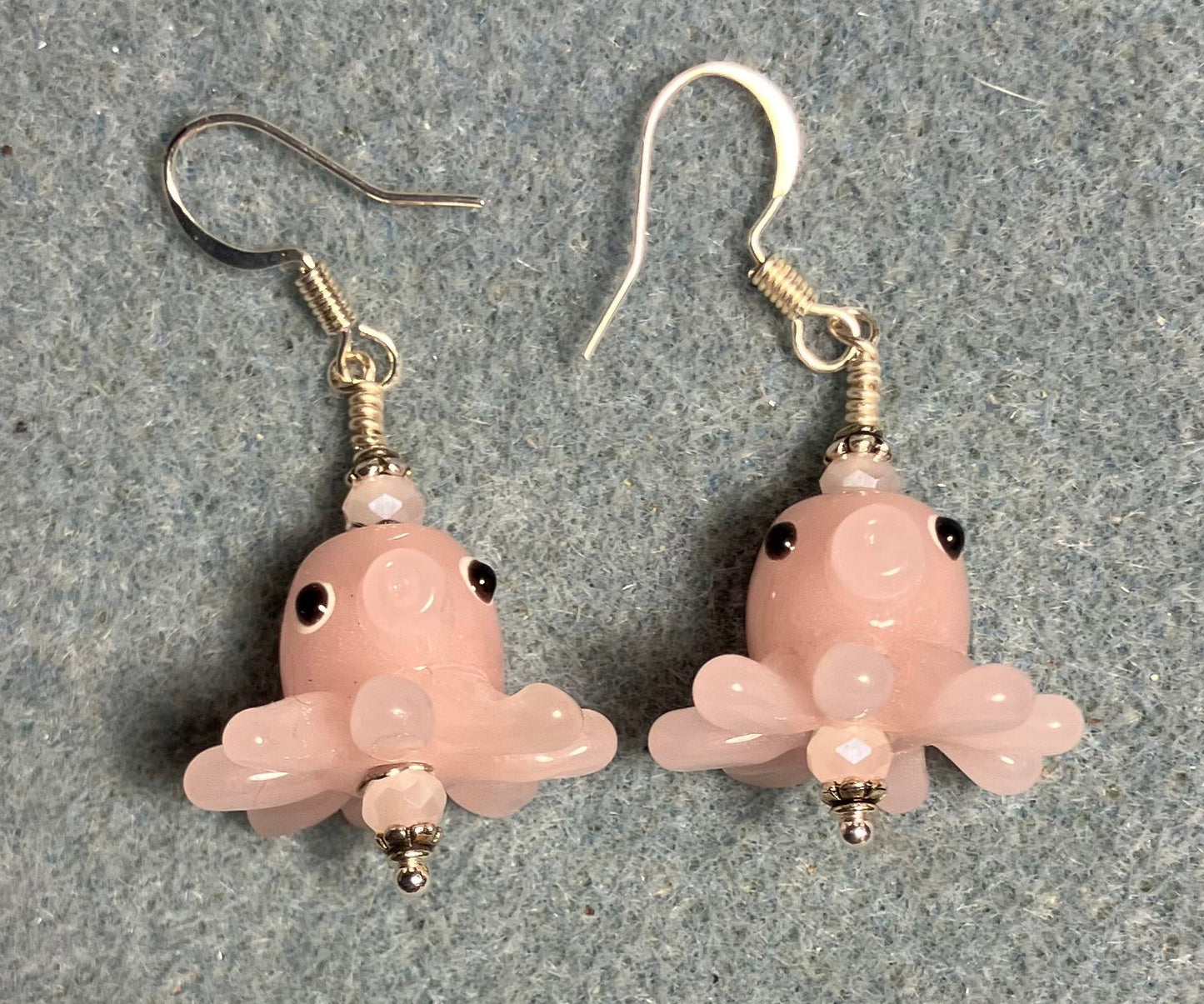 Pink lamp work octopus bead earrings adorned with pink Chinese crystal beads.