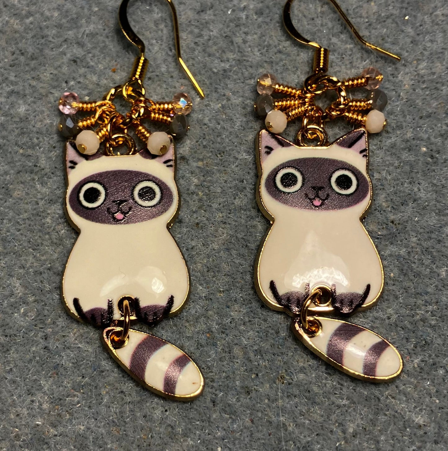 Gray and white enamel tabby cat charm earrings adorned with tiny dangling gray, pink, and white Chinese crystal beads.