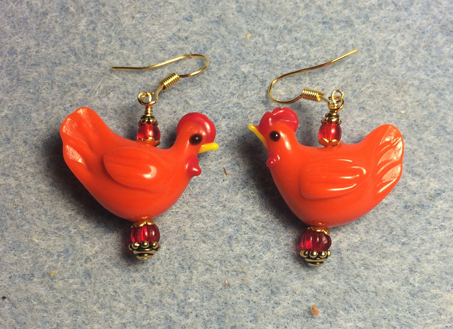 Red lamp work chicken bead earrings adorned with red Czech glass beads.
