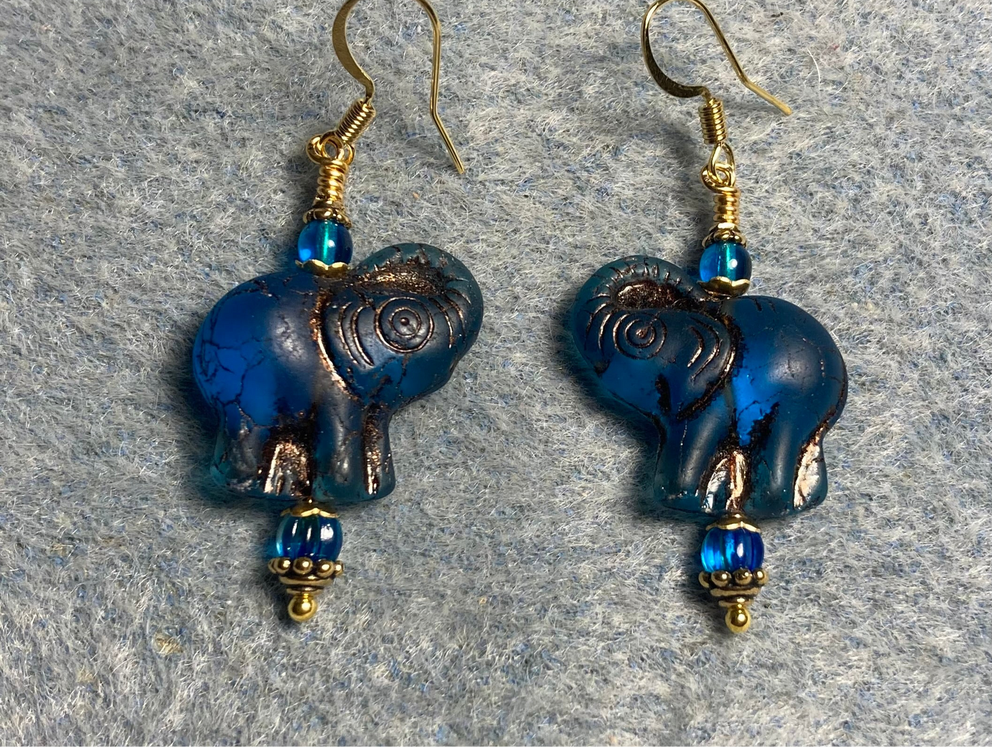 Dark turquoise (with copper inlay) Czech glass elephant bead earrings adorned with turquoise Czech glass beads.