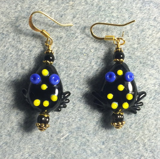 Opaque black lamp work frog bead earrings adorned with black Czech glass beads.