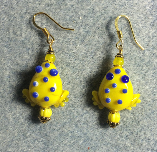 Opaque yellow lamp work frog bead earrings adorned with yellow Czech glass beads.