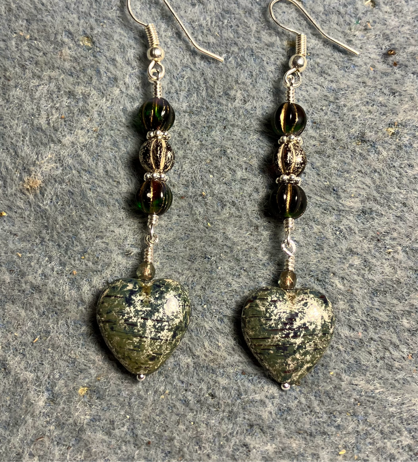 Green silver mottled Czech glass heart bead earrings adorned with green and silver Czech glass melon beads.