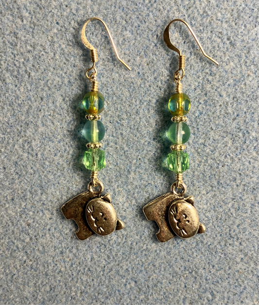 Silver cat charm earrings adorned with light green Czech glass beads