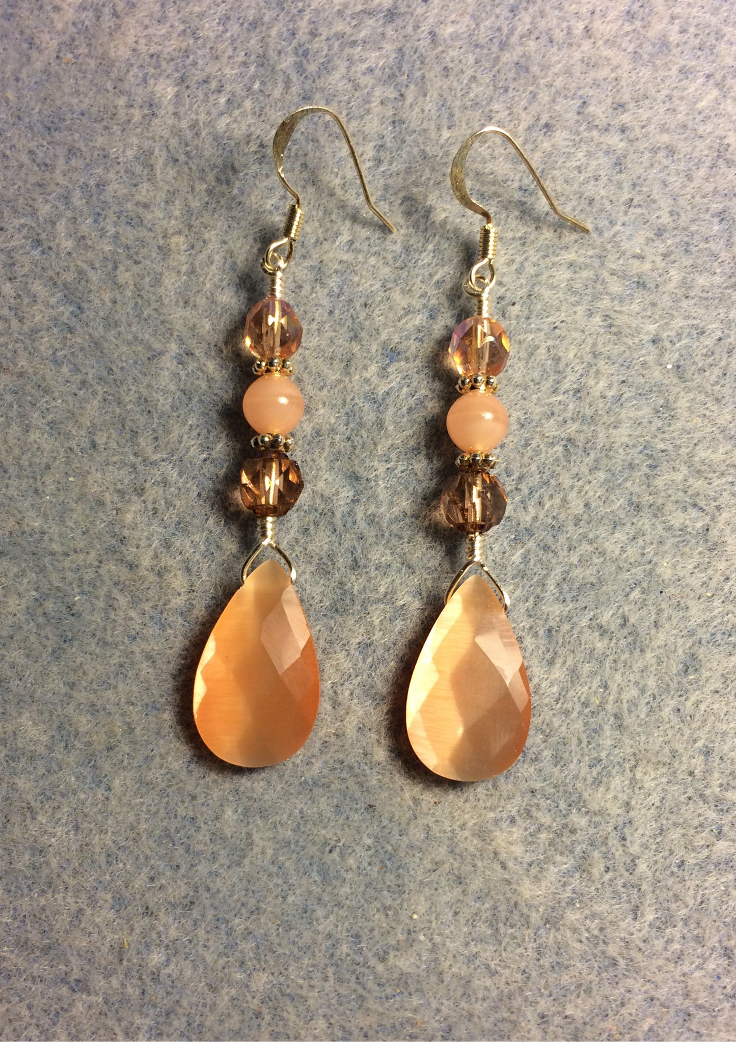 Peach fiber optic briolette bead earrings adorned with peach Czech glass beads.