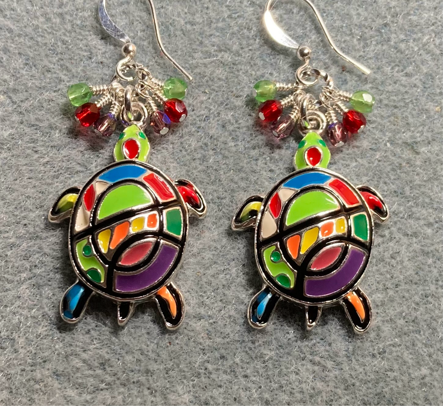 Large lime green, red, and purple enamel turtle charm earrings adorned with small dangling lime green, red, and purple Czech glass beads.