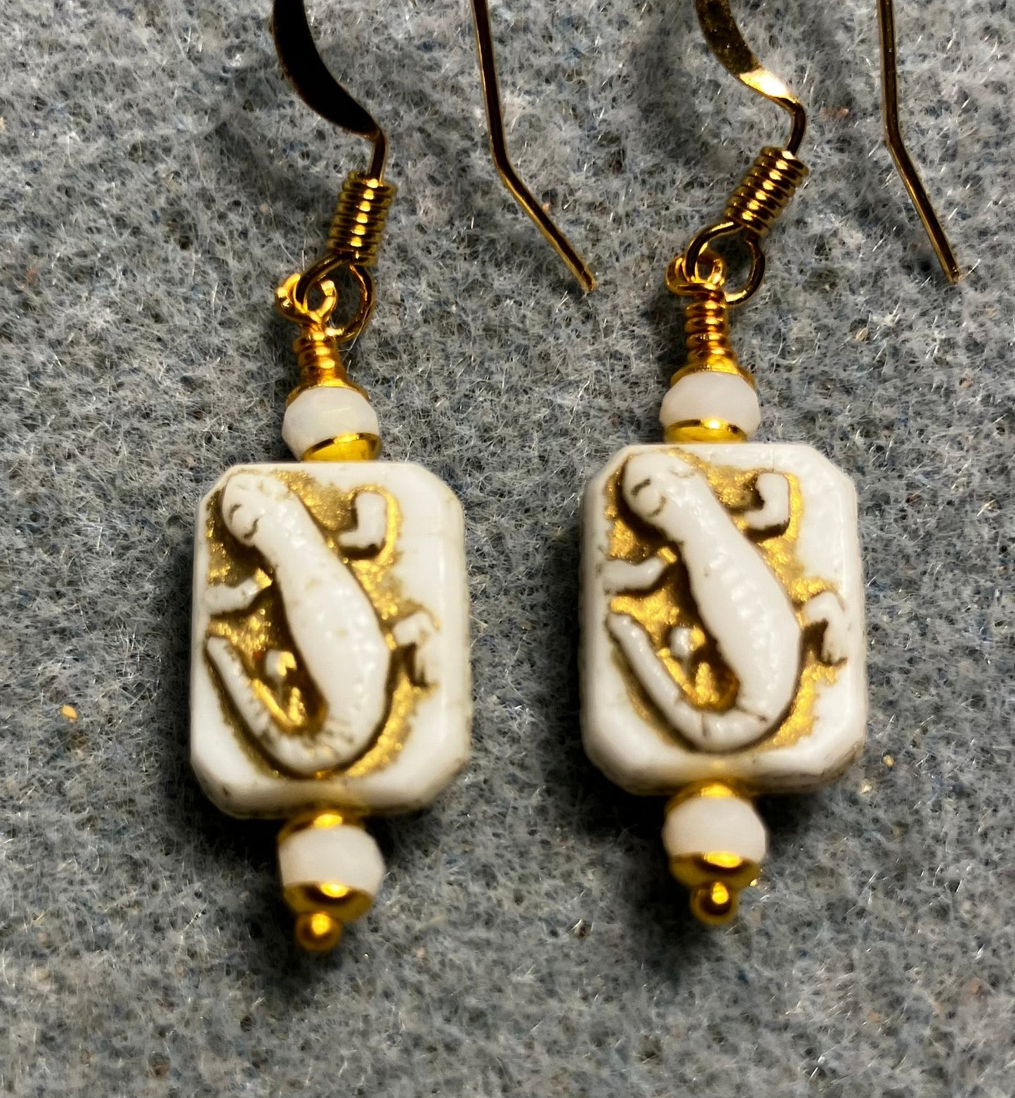 Small white and gold Czech glass lizard bead earrings adorned with white Chinese crystal beads.