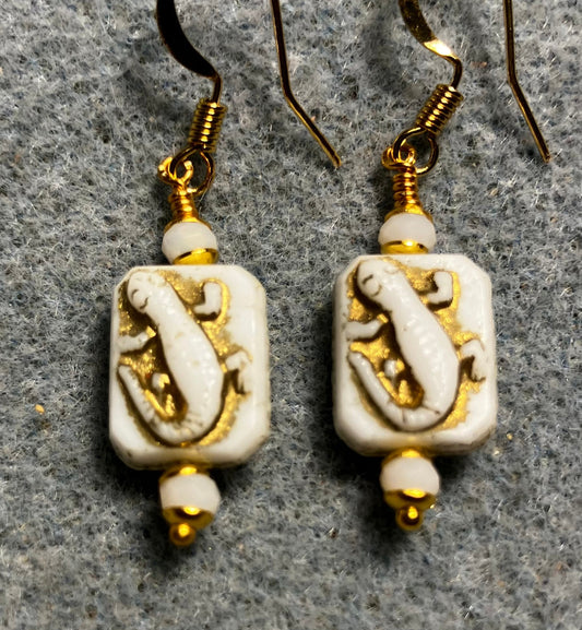 Small white and gold Czech glass lizard bead earrings adorned with white Chinese crystal beads.