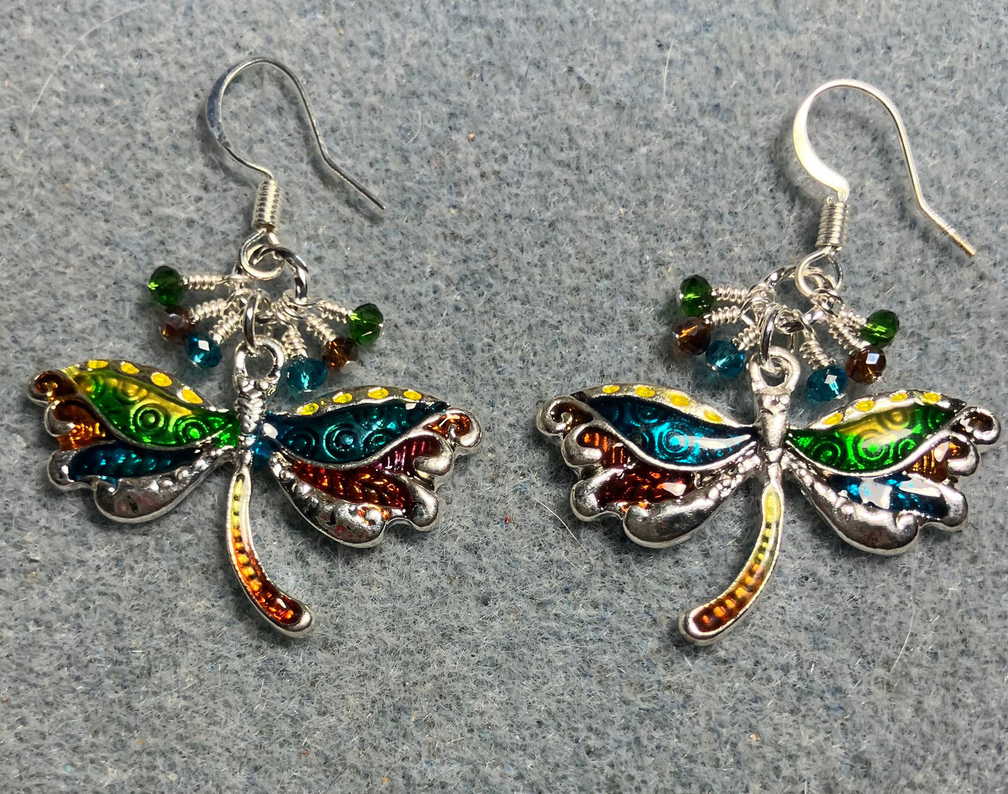 Turquoise, brown,and green dragonfly charm earrings adorned with tiny dangling turquoise, brown, and green Chinese crystal beads.
