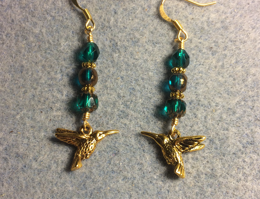 Gold Tierracast hummingbird charm earrings adorned with teal Czech glass beads