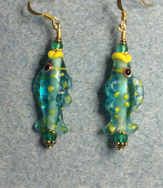 Turquoise and yellow lamp work fish bead earrings adorned with turquoise Czech glass beads.