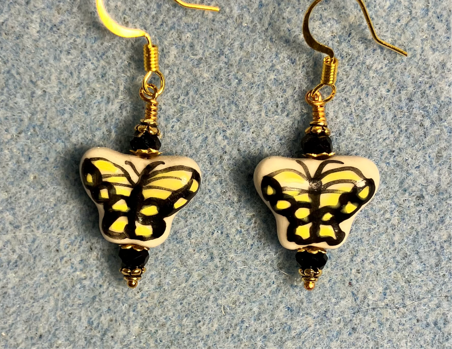 Yellow and black ceramic Monarch butterfly bead earrings adorned with black Chinese crystal beads.