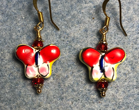 Red,pink, and yellow ceramic butterfly bead earrings adorned with red Chinese crystal beads.