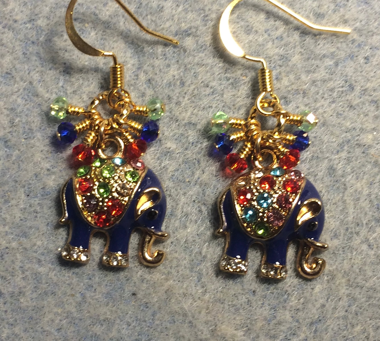 Dark blue enamel and colorful rhinestone elephant charm earrings adorned with tiny dangling red, dark blue, and light green Chinese crystal beads.