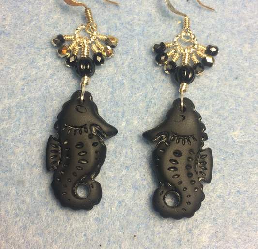 Black sea glass seahorse pendant bead earrings adorned with black Czech glass beads and small dangling black Czech glass beads.