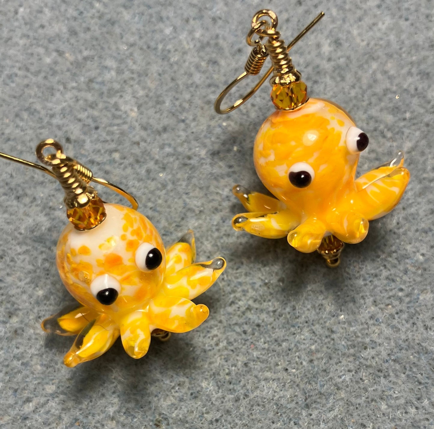 Tangerine and white mottled lamp work octopus bead earrings adorned with tangerine Chinese crystal beads.