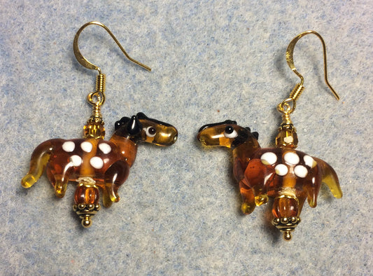 Translucent caramel and white lamp work spotted horse bead earrings adorned with caramel Czech glass beads.