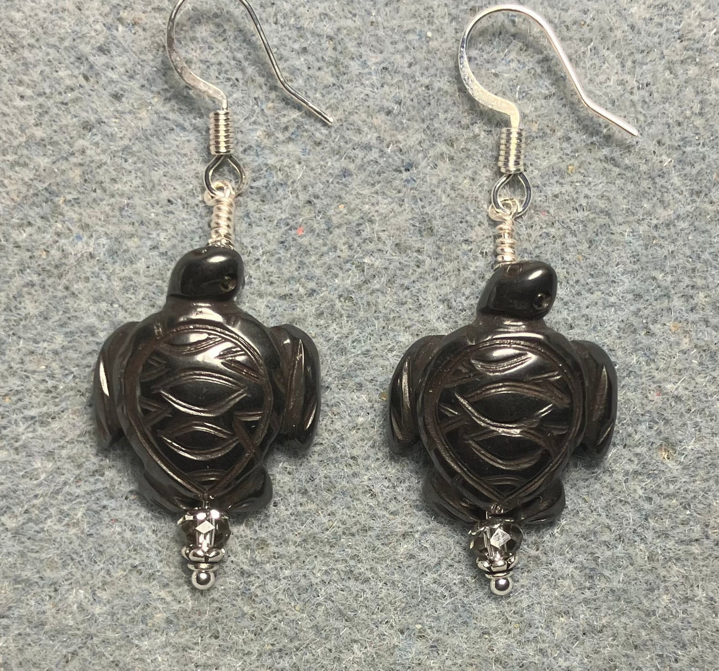 Hematite gemstone sea turtle bead earrings adorned with gray Chinese crystal beads.