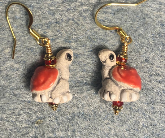 Small red and tan ceramic turtle bead earrings adorned with red Chinese crystal beads.